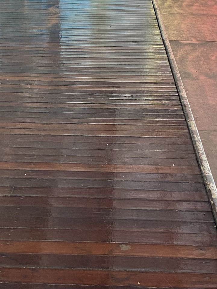 Deck boards with a fresh, dark, glossy coat.