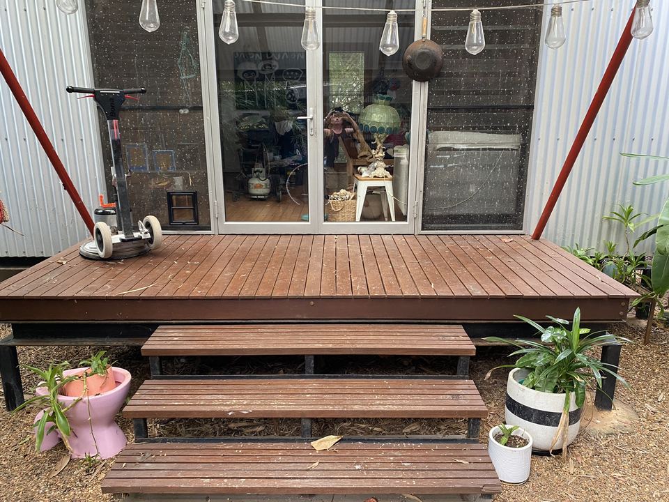 Restored timber deck and steps at the front of a house.