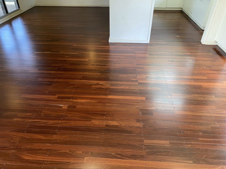 Rich red-brown hardwood floor with a fresh polished finish.