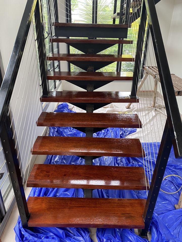 Open-tread staircase with freshly polished timber treads.